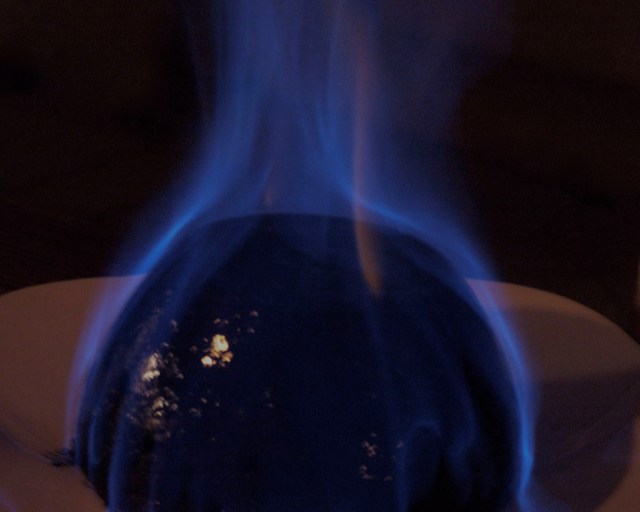 Christmas pudding with flaming brandy. Photo by James Scott-Brown, on Wikimedia.